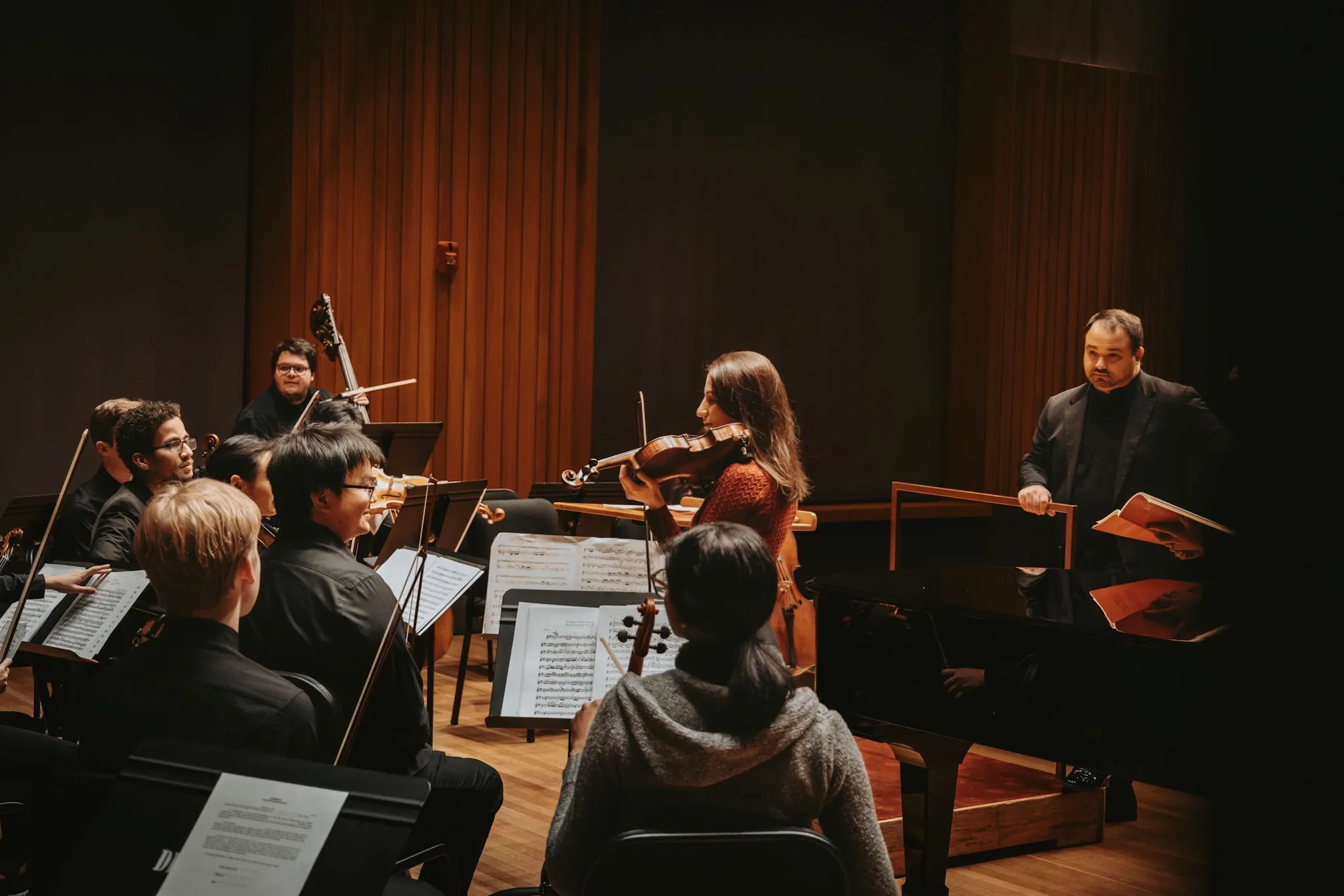 Tatev Muradyan leading an orchestra rehearsal as concertmaster.