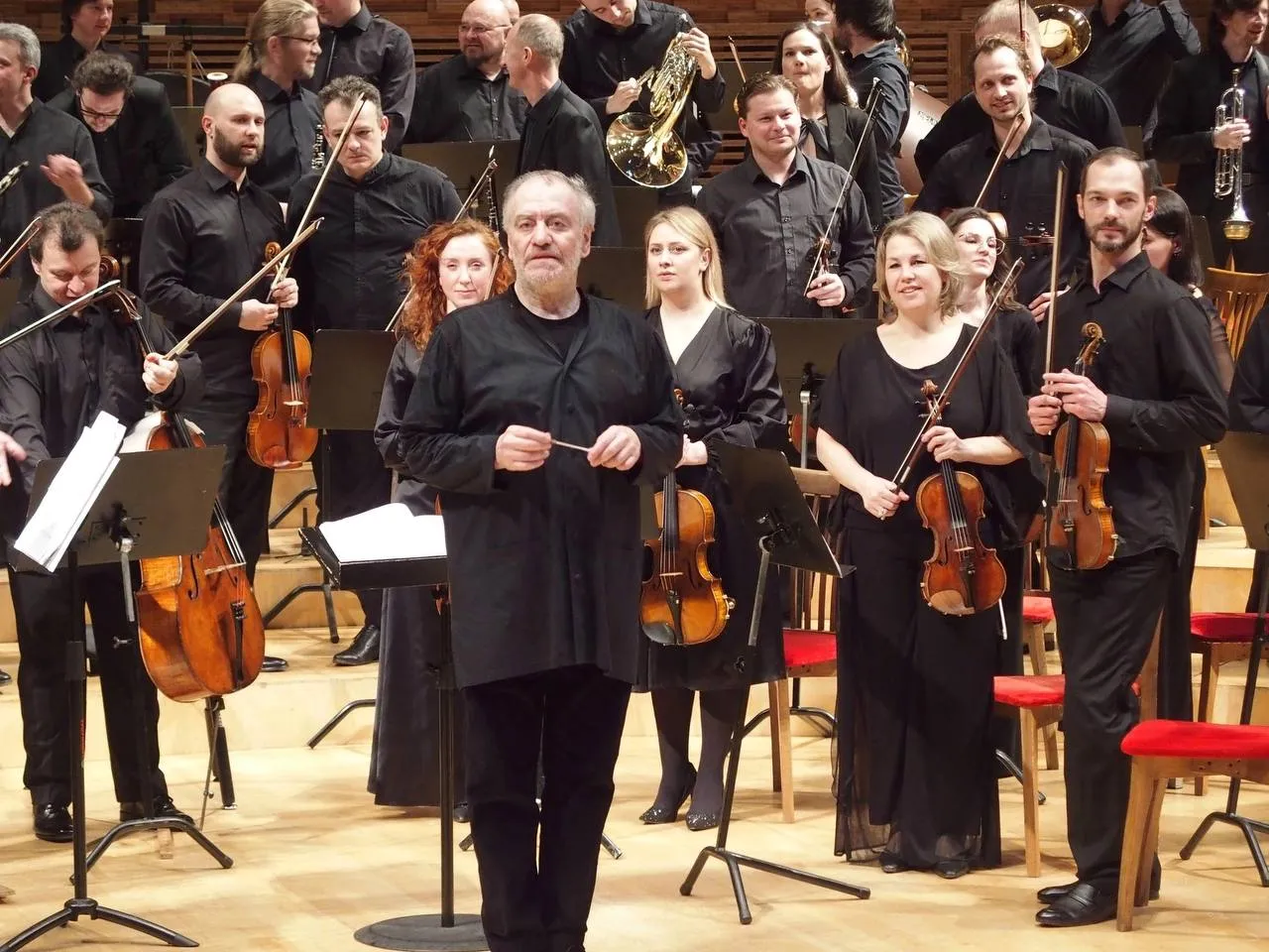 Tatev Muradyan performing on stage at the Mariinsky Theatre Concert Hall with the orchestra and conductor Valery Gergiev.